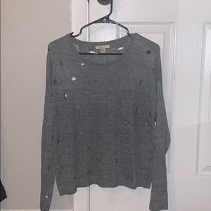 A trendy sweater with holes